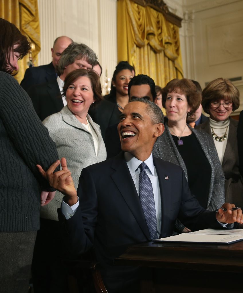 WASHINGTON, DC - MARCH 13: U.S. President Barack Obama jokes with guests before signing a presidential memorandum for modernizing overtime protections for workers during an event in the East Room of the White House, on March 13, 2014 in Washington, DC. (Photo by Mark Wilson/Getty Images)