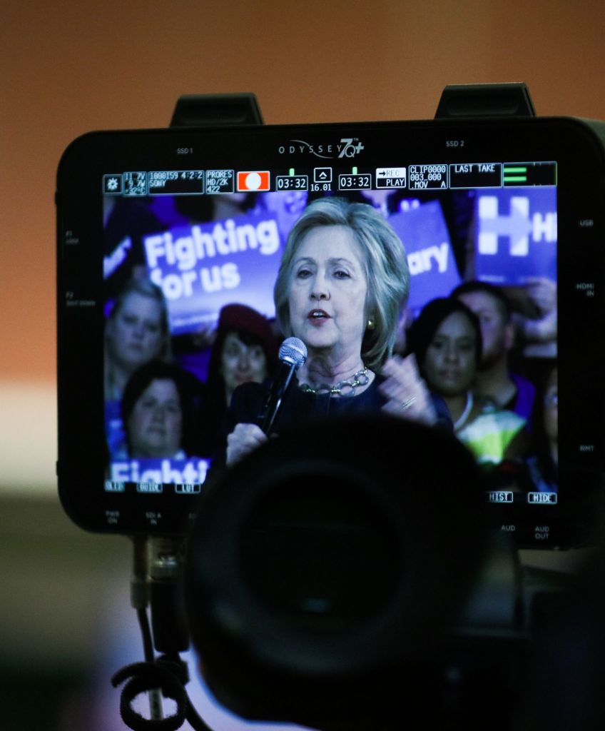 A cameraman checks his camera as Democratic presidential candidate Hillary Clinton speaks to supporters during a rally in Oakland, California, on May 6, 2016. / AFP / GABRIELLE LURIE (Photo credit should read GABRIELLE LURIE/AFP/Getty Images)