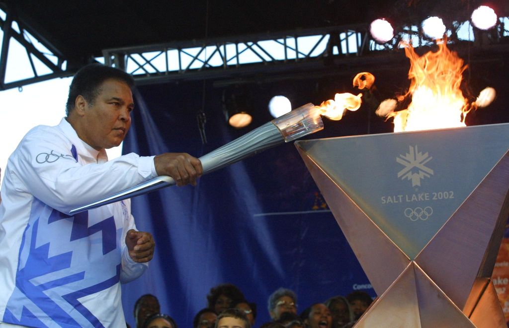 1968 Olympic gold medalist Muhammad Ali lights the first torch to start the Olympic Torch Relay at Centennial Olympic Park in Atlanta. (Chris Stanford/AFP/Getty Images)