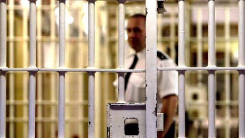Prison guard seen through bars