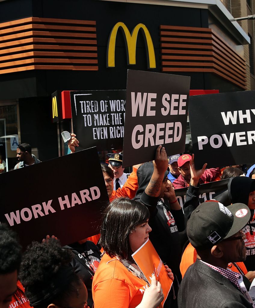 Low-wage workers, many in the fast-food industry, join with supporters in front of a New York City McDonald's to demand a minimum wage of $15 an hour. Home care workers, and employees at Walmart and fast food restaurants say that the current minimum is not a living wage. (Photo by Spencer Platt/Getty Images)