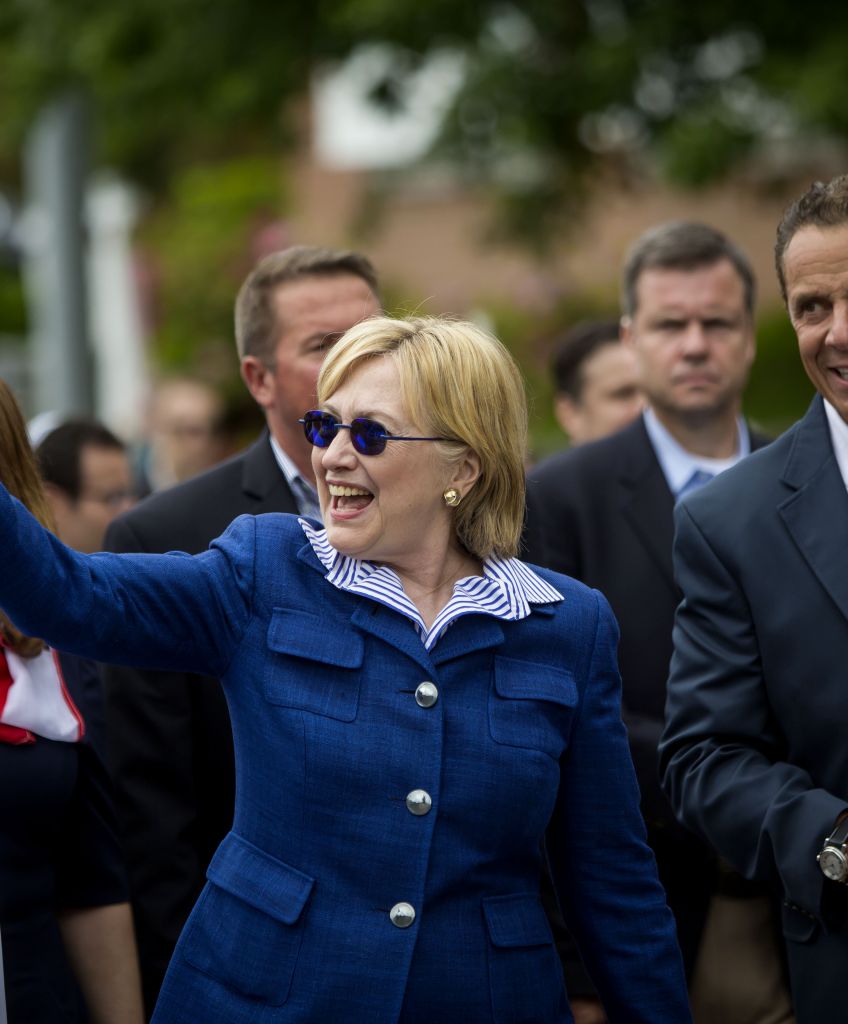 Hillary Clinton and New York Governor Andrew M. Cuomo walk in the 2016 Memorial Day parade in Chappaqua, New York. (Photo by Eric Thayer/Getty Images)
