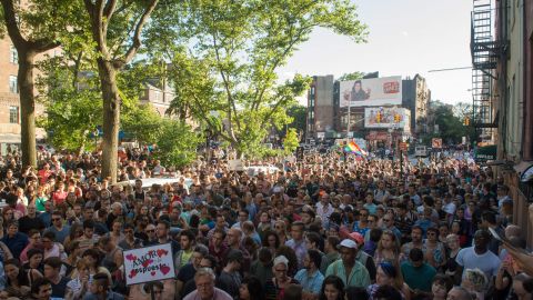 People gather near the Stonewall Inn, a civil rights landmark in New York City, during a vigil in reaction to the mass shooting at a gay nightclub in Orlando, Florida, on June 12, 2016. (BRYAN R. SMITH/AFP/Getty Images)