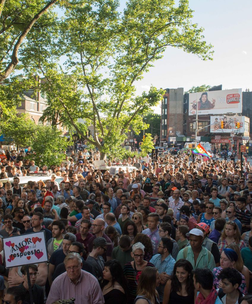 People gather near the Stonewall Inn, a civil rights landmark in New York City, during a vigil in reaction to the mass shooting at a gay nightclub in Orlando, Florida, on June 12, 2016. (BRYAN R. SMITH/AFP/Getty Images)