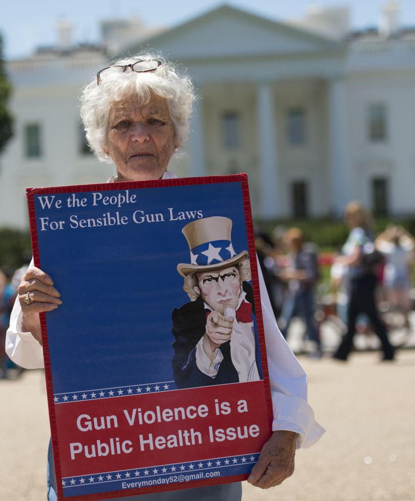 A woman walks with a sign to protest gun violence and call for sensible gun laws outside the White House, June 13, 2016 (MOLLY RILEY/AFP/Getty Images)
