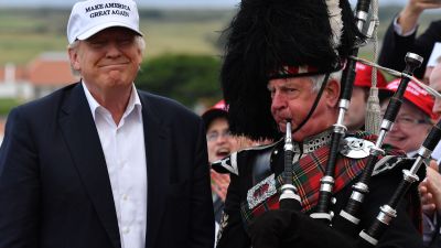 Donald Trump with bagpipe player in Scotland