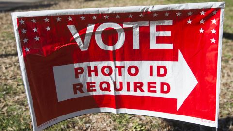 Polling place sign alerting voters "photo ID required."