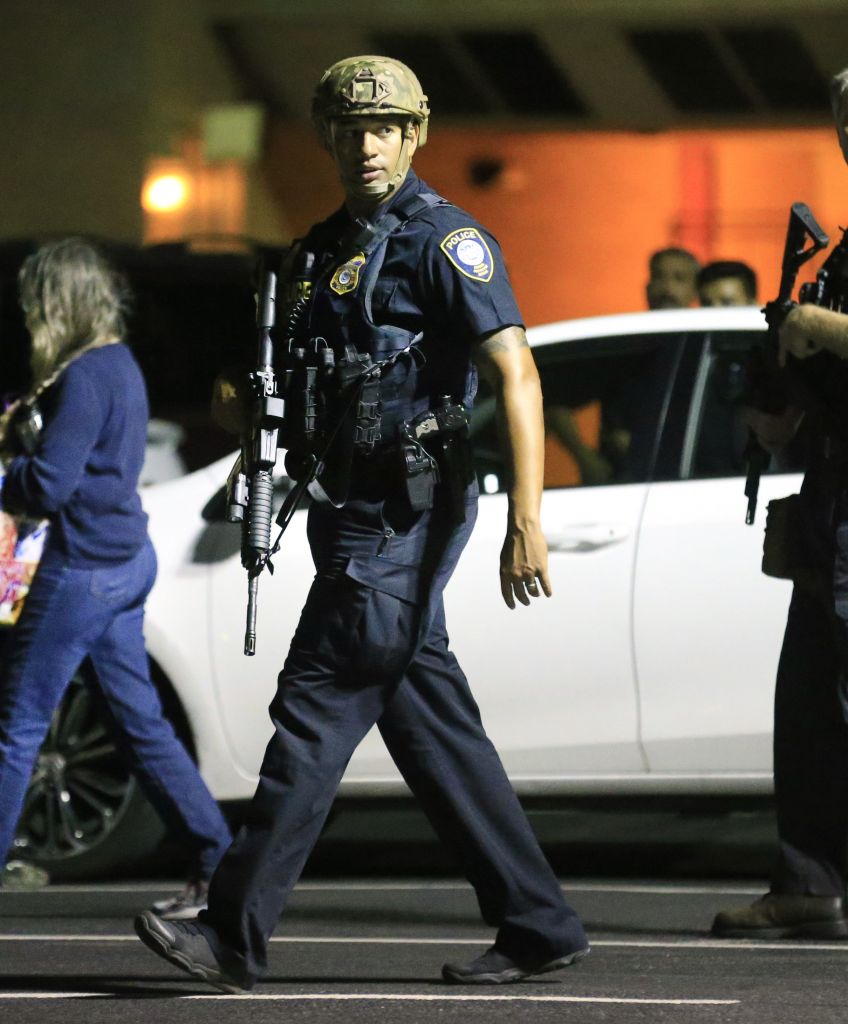Dallas police officers escort residents away from the scene where twelve Dallas police officers were shot and five have now died. (Photo by Ron Jenkins/Getty Images)