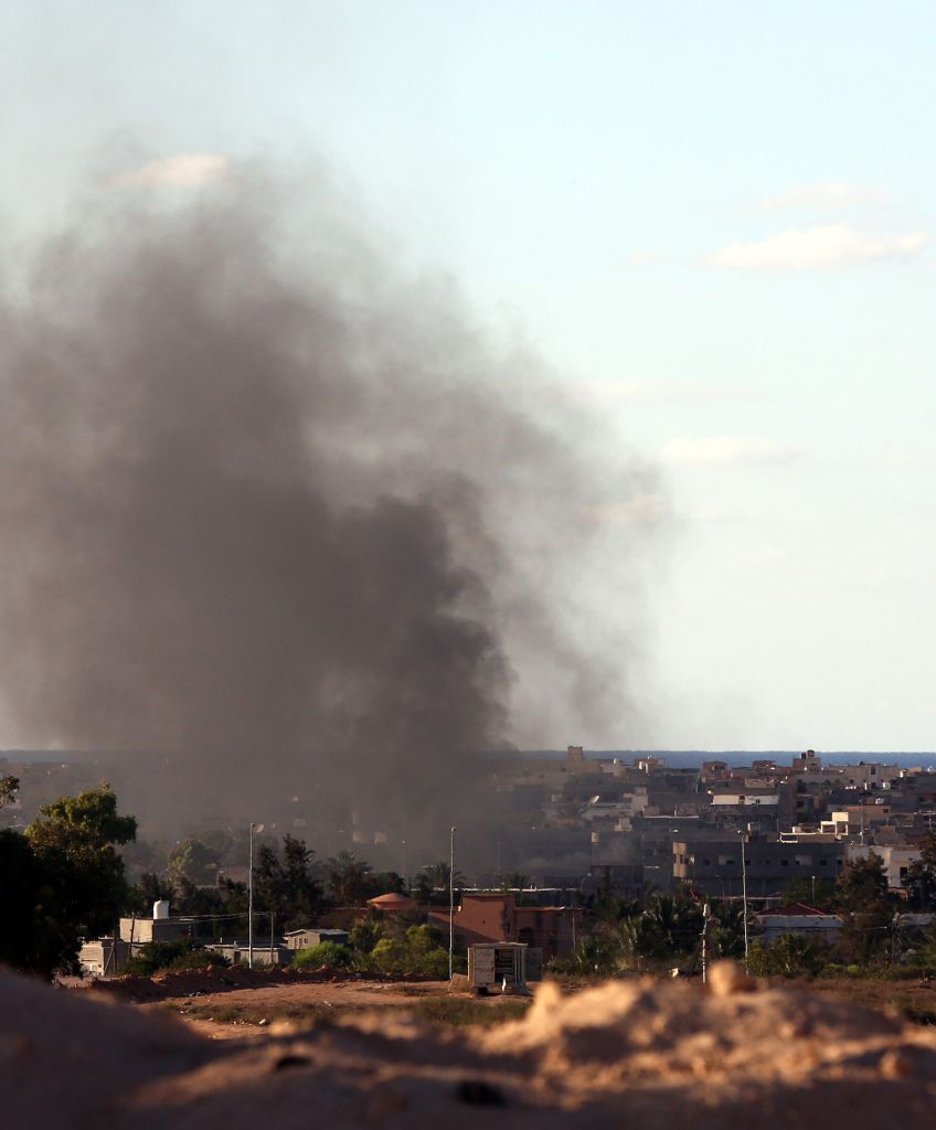 Smoke billows from buildings after a recent air attack targeting Islamic State group positions in Libya. (MAHMUD TURKIA/AFP/Getty Images)