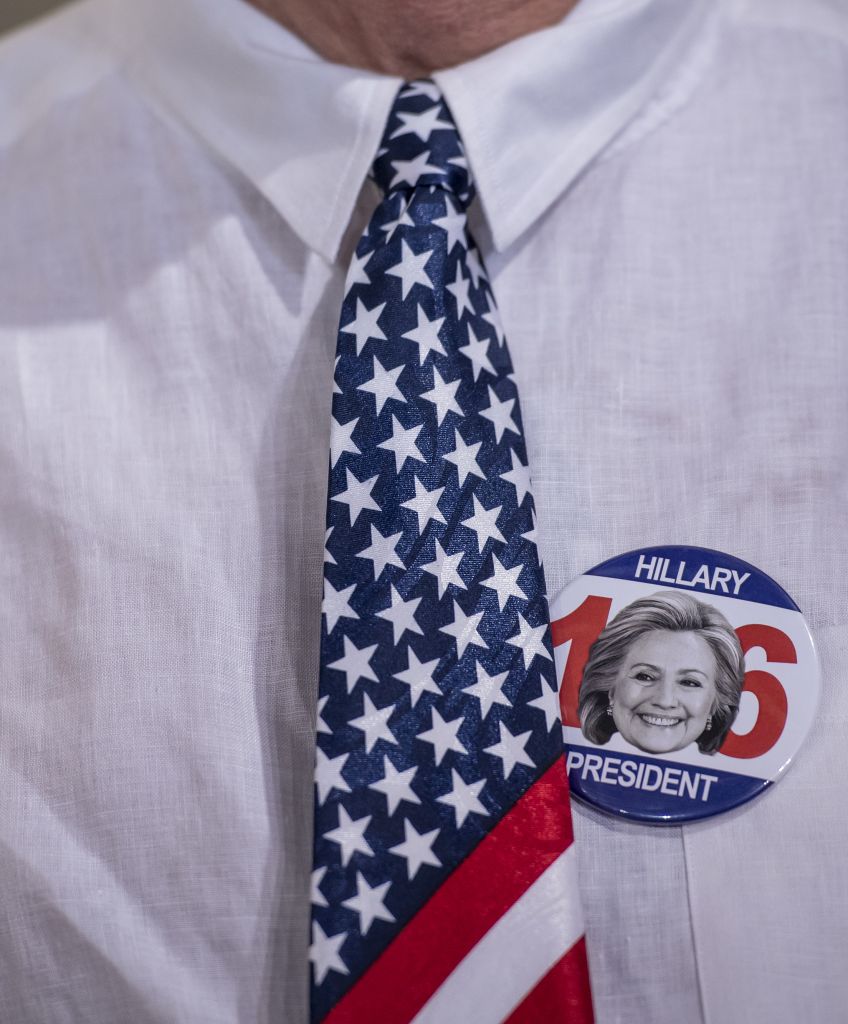A attendee wears an American flag themed tie and a campaign button for Hillary Clinton during a campaign event in Las Vegas, Nevada, on Thursday, Aug. 4, 2016. (David Paul Morris/Bloomberg via Getty Images)