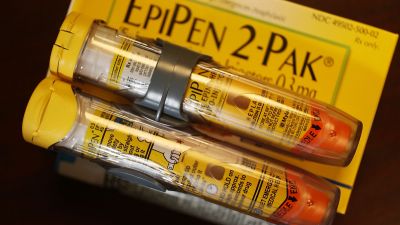 Since Mylan acquired EpiPen in 2007, the cost for a two-pack of the devices has soared nearly 550 percent to $608.61. That’s a price far beyond the means of families with kids threatened by possibly fatal allergic reactions. (Photo Illustration by Joe Raedle/Getty Images)