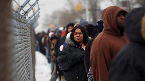 People wait in a several-blocks-long line to receive food and gifts at the "A Miracle in Motown" event, part of a nationwide program to help working poor and disadvantaged families on Dec. 18, 2008 in Detroit. (Photo by Spencer Platt/Getty Images)