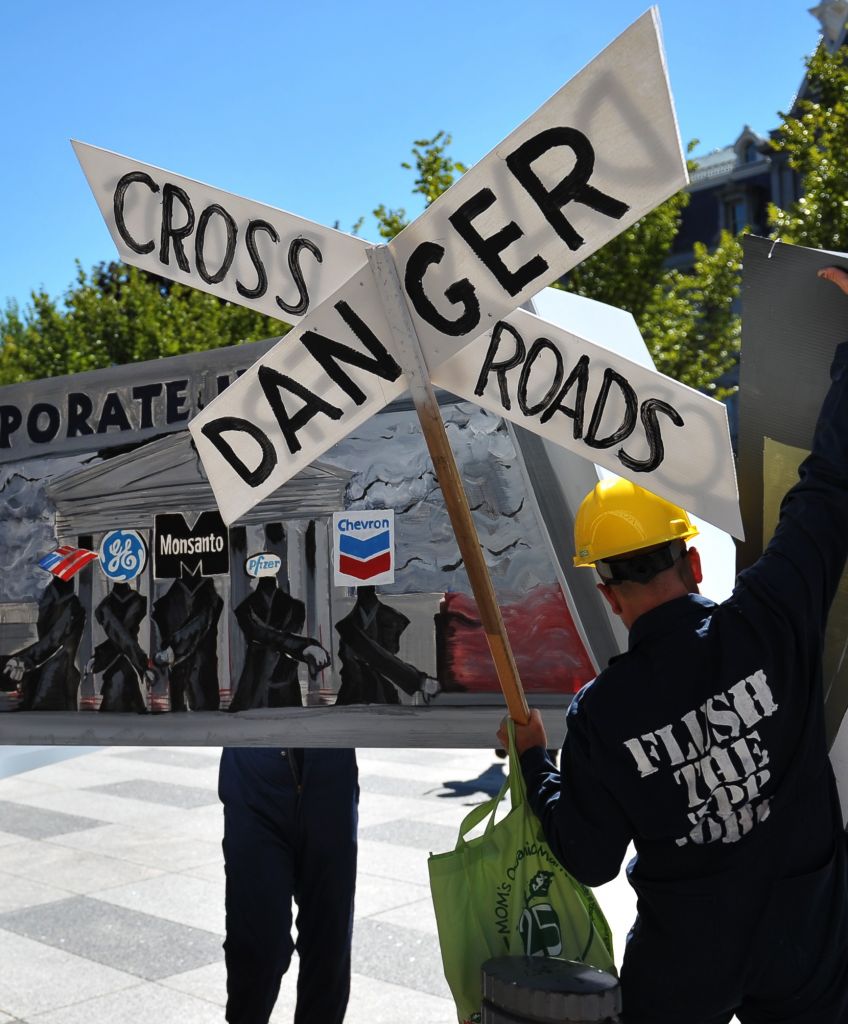 Demonstrators protesting against the Trans-Pacific Partnership (TPP) are seen on Pennsylvania Avenue, near the White House, on Sept. 24, 2013 in Washington, DC. (Photo by Mandel Ngan/AFP/Getty Images)