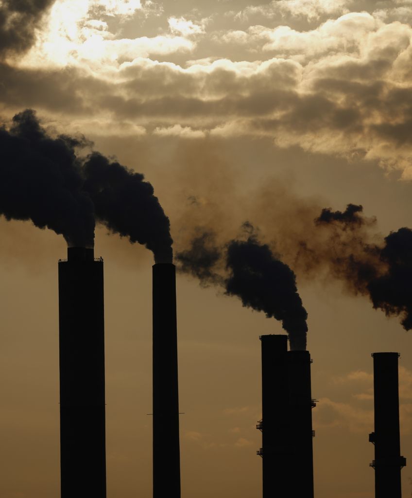 The silhouettes of emissions are seen rising from stacks of the Duke Energy Corp. Gibson Station power plant at dusk in Owensville, Indiana, U.S., on Thursday, July 23, 2015. (Luke Sharrett/Bloomberg via Getty Images)