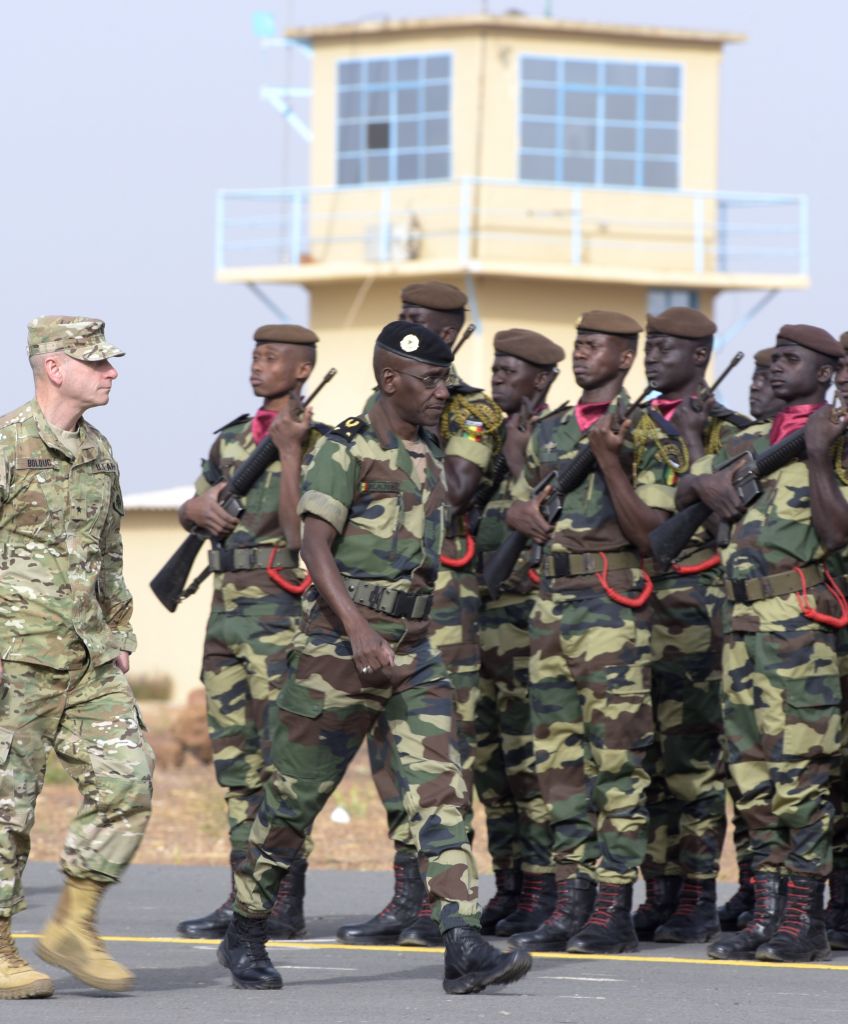 US Army Brigadier Gen. Donald Bolduc (left) and Senegal's Army Gen. Amadou Kane review the troops during the inauguration of a military base in Thies, 70 km from Dakar, on Feb. 8, 2016, the second day of a three-week joint military exercise between African, US and European troops, known as Flintlock. (Photo by Seyllou/AFP/Getty Images)