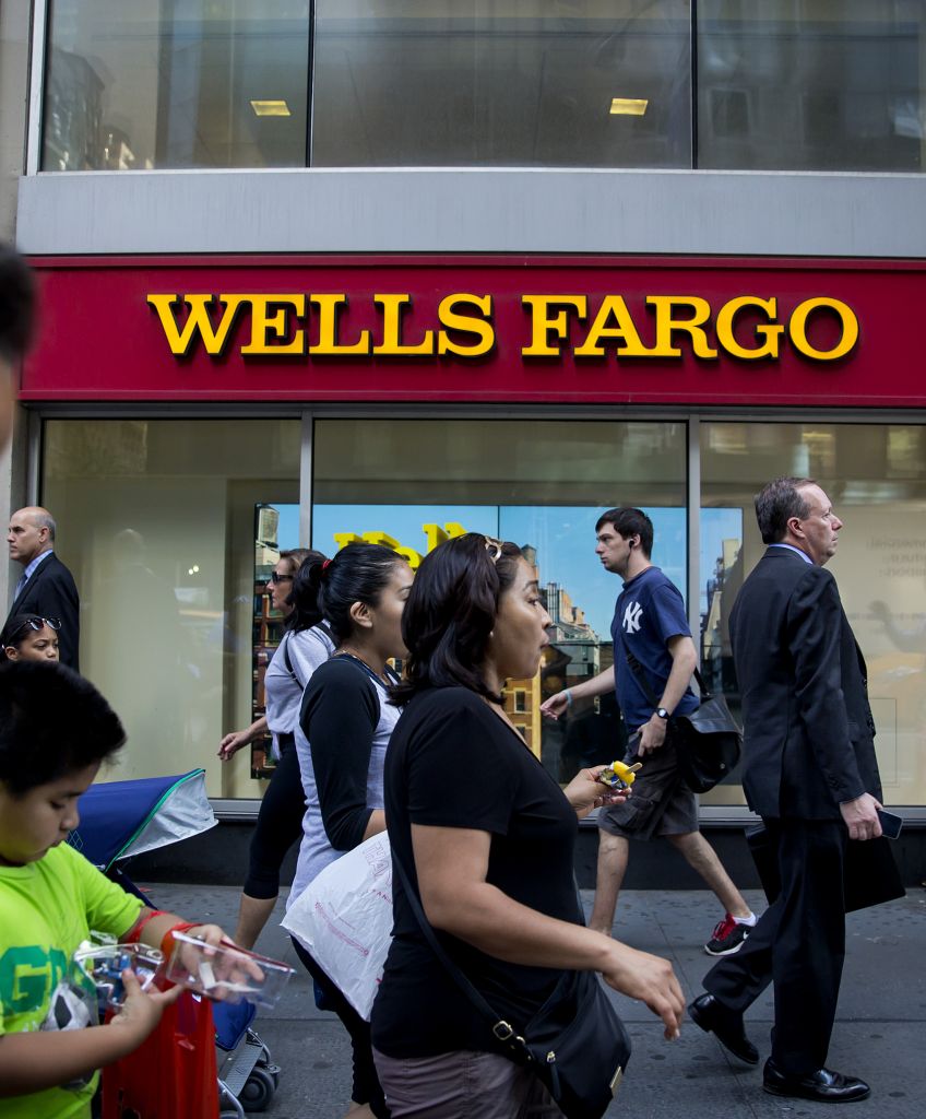 Pedestrians pass in front of a Wells Fargo & Co. bank branch in New York City (Photographer: Eric Thayer/Bloomberg via Getty Images)