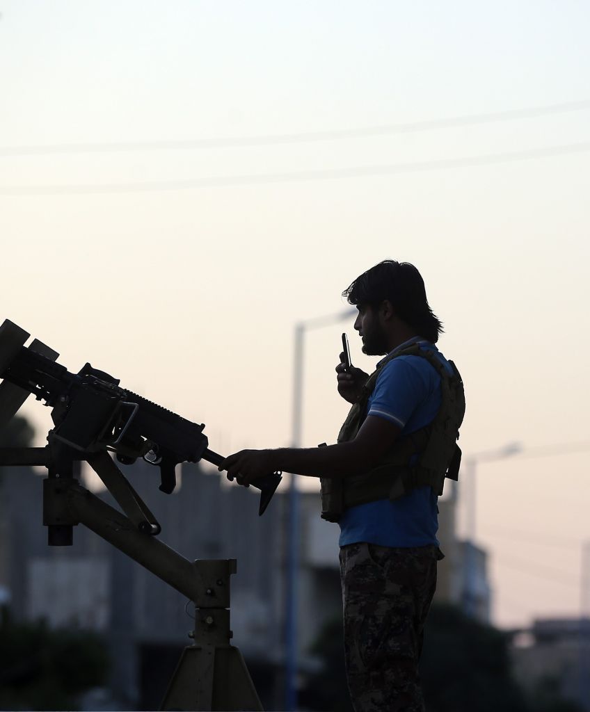 Syrians performed their Eid Al-Adha prayer at the Ebul Hasan Mosque as Free Syrian Army members stand guard at the Muhatta Street. (Photo by Emin Sansar/Anadolu Agency/Getty Images)