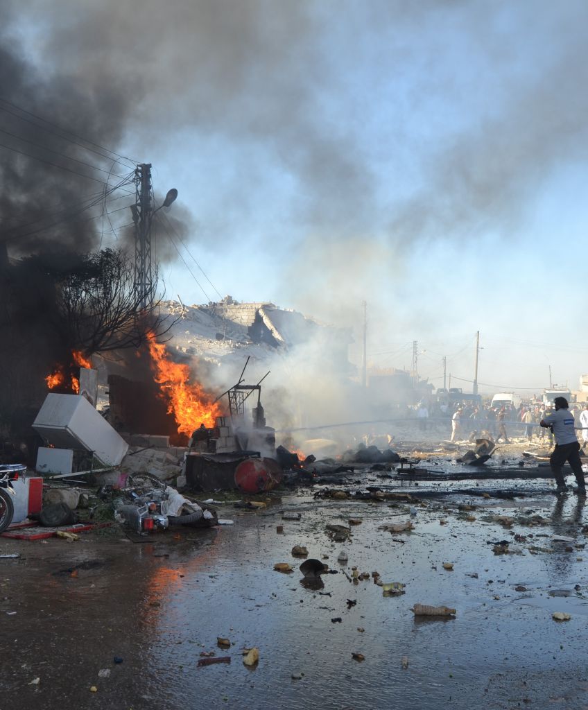 In Syria, a building burns after Assad regime airstrikes on opposition-controlled areas in Idlib on September 12, 2016. At least 10 people were killed and 17 people were wounded. (Photo by Bhjat Najar/Anadolu Agency/Getty Images)