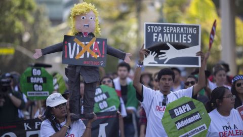Protestors carrying pinata likeness of Donald Trump.