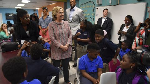 Democratic presidential candidate Hillary Clinton, greets students as she is joined by NBA Hall-of-Famer Alonzo Mourning and his wife Tracy, rear center, during a visit to Overtown Youth Center on October 11, 2016 in Miami, Fl. Overtown Youth Center is a project of the Mourning Family Foundation, OYC was founded in 2003 by Mourning in hopes of creating a safe haven for children living in Overtown, a historically Black and predominately low-income community in Miami. (Photo by Ricky Carioti/The Washington Post via Getty Images)
