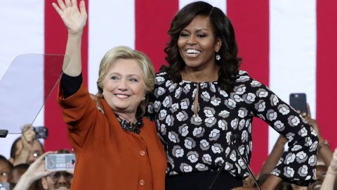 Democratic presidential candidate Hillary Clinton and first lady Michelle Obama greet supporters during a campaign event at the Lawrence Joel Veterans Memorial Coliseum in Winston-Salem, North Carolina on Oct. 27, 2016. The first lady joined Clinton for the first time to campaign for the presidential election. (Photo by Alex Wong/Getty Images)