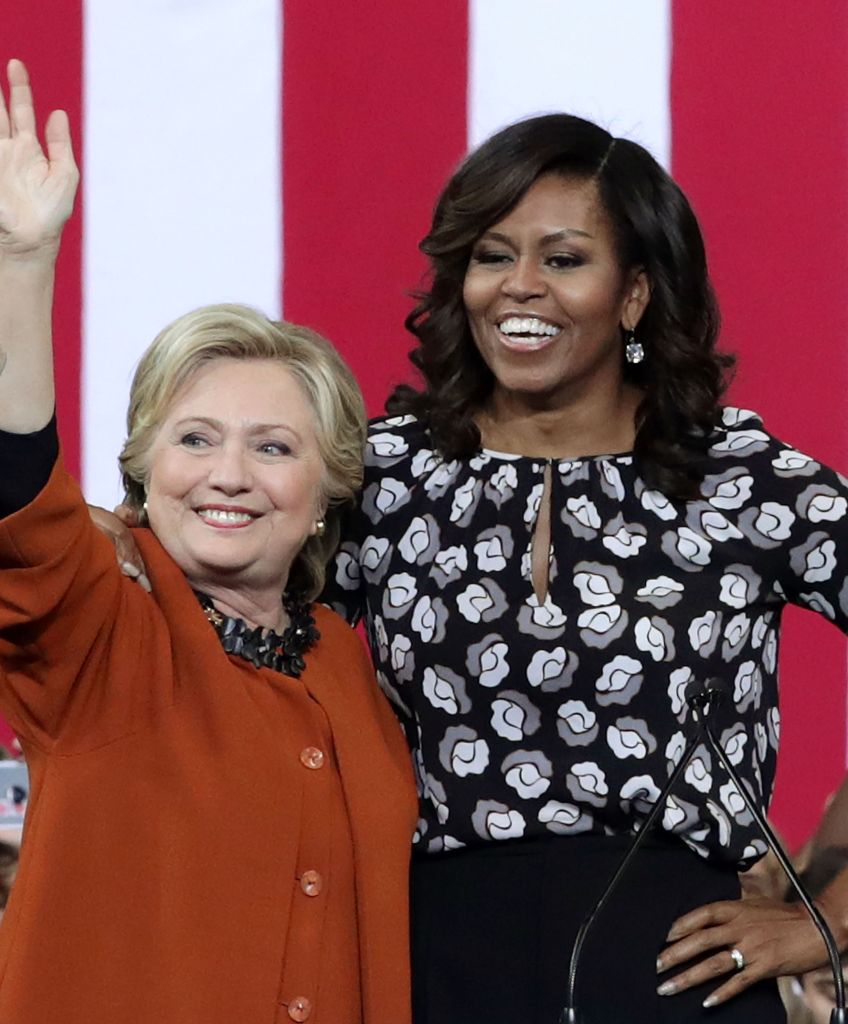 Democratic presidential candidate Hillary Clinton and first lady Michelle Obama greet supporters during a campaign event at the Lawrence Joel Veterans Memorial Coliseum in Winston-Salem, North Carolina on Oct. 27, 2016. The first lady joined Clinton for the first time to campaign for the presidential election. (Photo by Alex Wong/Getty Images)