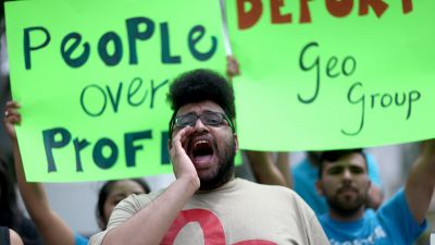 Ruben Hayslette and other protesters gather in front of the GEO Group headquarters to speak out against the company that manages private prisons across the United States on May 4, 2015 in Boca Raton, Florida. (Photo by Joe Raedle/Getty Images)