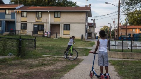 Children ride their scooters in Woodland Terrace, a public housing complex in Southeast Washington on Aug. 3, 2015. (Photo by Evelyn Hockstein for The Washington Post via Getty Images)