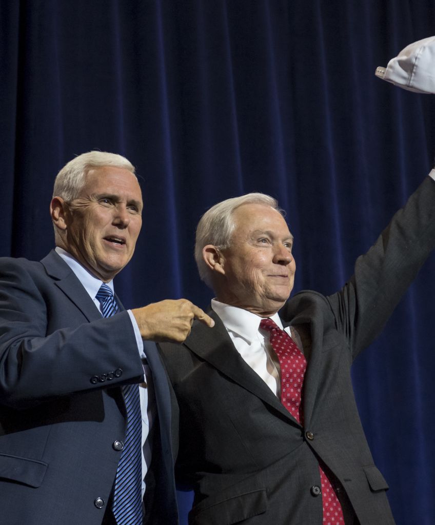 Mike Pence, 2016 Republican vice presidential nominee, left, and Senator Jeff Sessions, Republican from Alabama, gesture during a campaign event for Donald Trump in Phoenix, Arizona. Photographer: David Paul Morris/Bloomberg via Getty Images