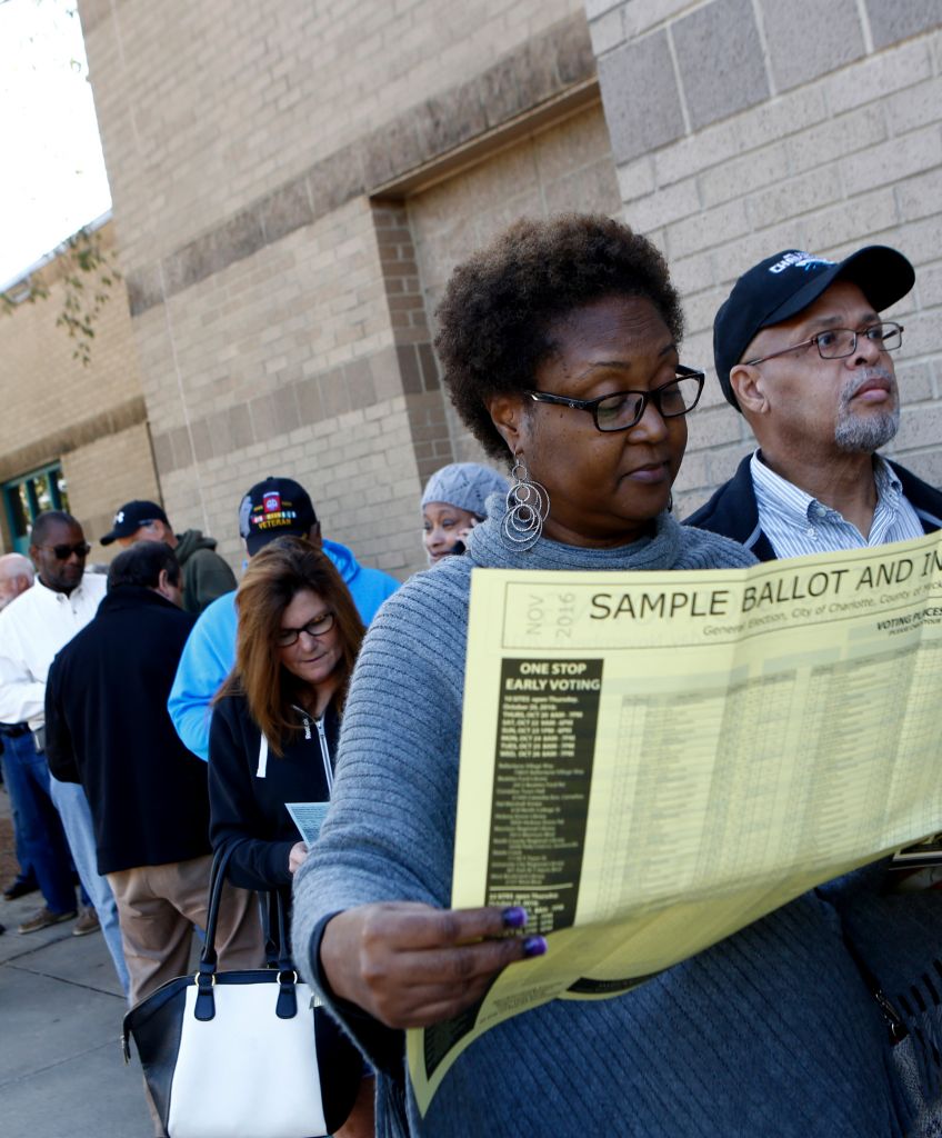 Mavis Wilson looks over a sample ballot as she waits to early vote with her husband, Ron Wilson at Charlotte Mecklenburg University City Library on October 24, 2016 in Charlotte, North Carolina. (Photo by Brian Blanco/Getty Images)