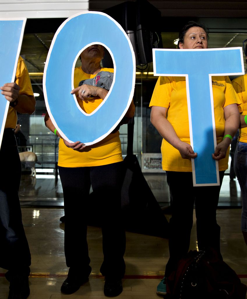 Activists carrying letters spelling V-O-T-A