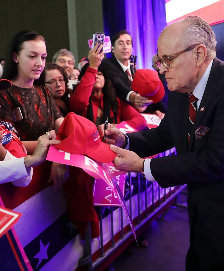 Former New York City Mayor Rudy Giuliani gives autographs during a November campaign rally for Donald Trump in Reno, Nevada. (Photo by Chip Somodevilla/Getty Images)