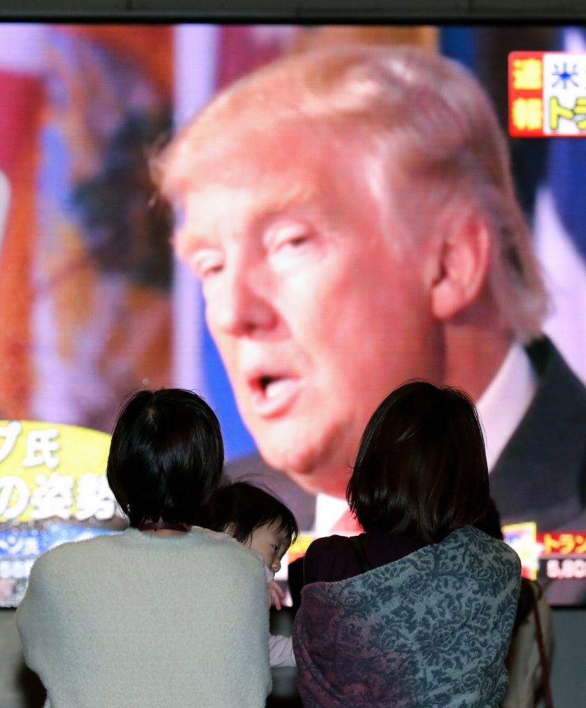 People watch a screen broadcasting the US President-elect Donald Trump on November 9, 2016 in Osaka, Japan. Donald Trump defeated Democratic presidential nominee Hillary Clinton to become the 45th president of the United States. (Photo by The Asahi Shimbun via Getty Images)