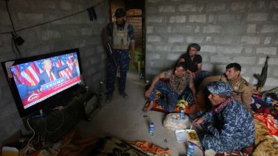 Members of the Iraqi military watch Donald Trump after the presidential election in the village of Arbid on the southern outskirts of Mosul on Nov. 9, 2016. The soldiers were resting in a house during the ongoing military operation to retake Mosul from ISIS. (Photo by Ahmad Al-Rubaye/AFP/Getty Images)