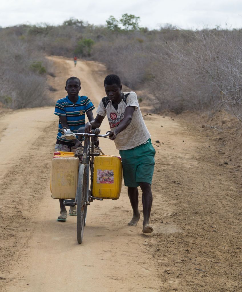 Kenyan villagers carry water during a drought that destroyed crops and animals in Kenya. Droughts like this will increase in frequency and severity as climate change intensifies. (Photo by Recep Canik/Anadolu Agency/Getty Images)