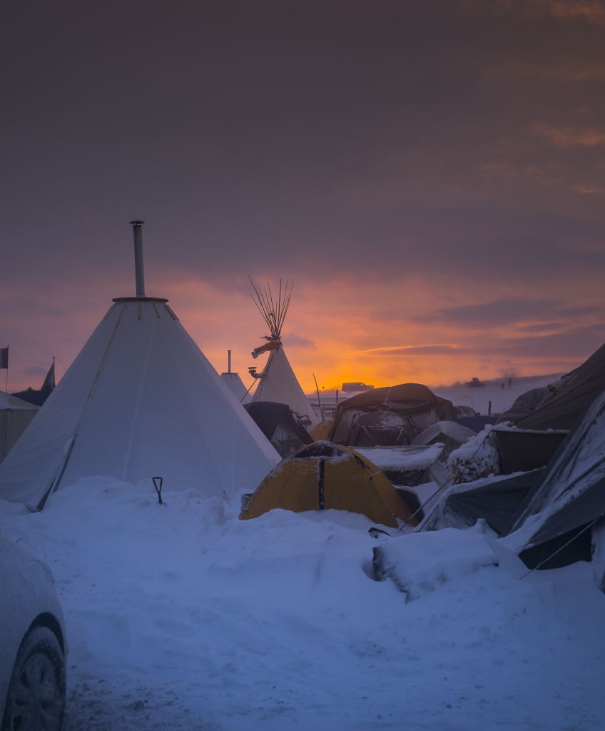 Winter has arrived in Standing Rock at the Oceti Sakowin Camp in North Dakota, the day after the Army Corps of Engineers denied the easement needed to build the pipeline. Despite driving snow and 40-plus mile an hour wind a group of 700-plus veterans and water protectors marched toward the barricade on highway 1806. (Photo by Michael Nigro/Pacific Press/LightRocket via Getty Images)