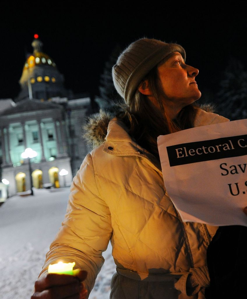 Ruth Fulton, 44, demonstrates during a candlelight vigil against President-elect Donald Trump outside the Colorado Capitol building on the eve of the Electoral College vote in Denver, Colorado, December 18, 2016. "The Electoral College is supposed to be a safeguard against exactly this sort of person," said Fulton. (CHRIS SCHNEIDER/AFP/Getty Images)