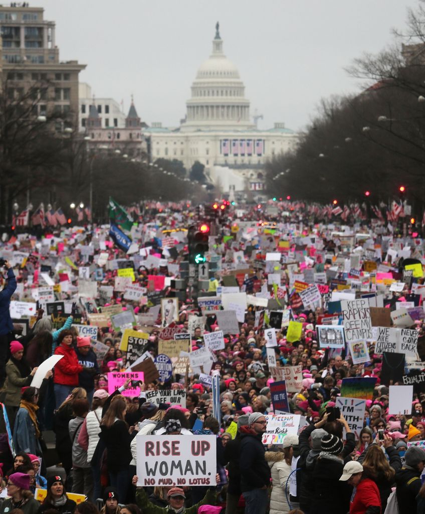 Protesters walk during the Women's March on Washington, with the US Capitol in the background, on January 21, 2017 in Washington, DC. (Photo by Mario Tama/Getty Images)