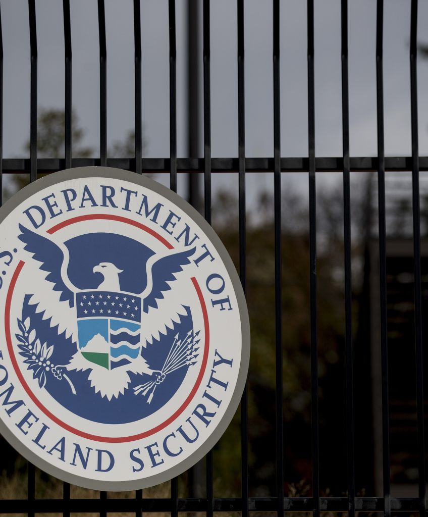 The US Department of Homeland Security (DHS) seal hangs on a fence at the agency's headquarters in Washington, DC. (Andrew Harrer/Bloomberg via Getty Images)