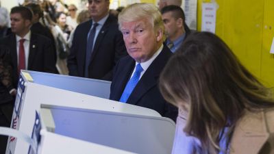 Then-Republican presidential nominee Donald Trump and his wife, Melania, fill out their ballots at a polling station in a school during the 2016 presidential elections on Nov. 8, 2016 in New York. (Photo by Mandel Ngan/AFP/Getty Images)