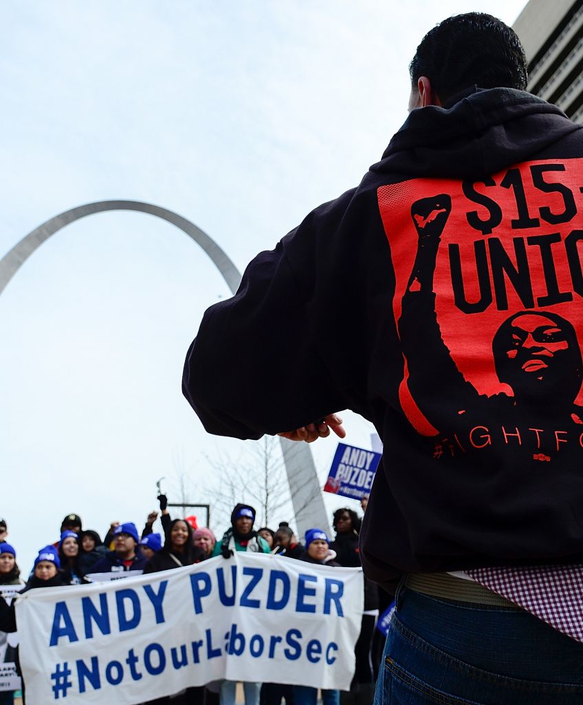 Protesters rally against Labor nominee Andrew Puzder outside of a Hardee's restaurant on February 13, 2017 in St Louis, Missouri. (Photo by Jeff Curry/Getty Images)