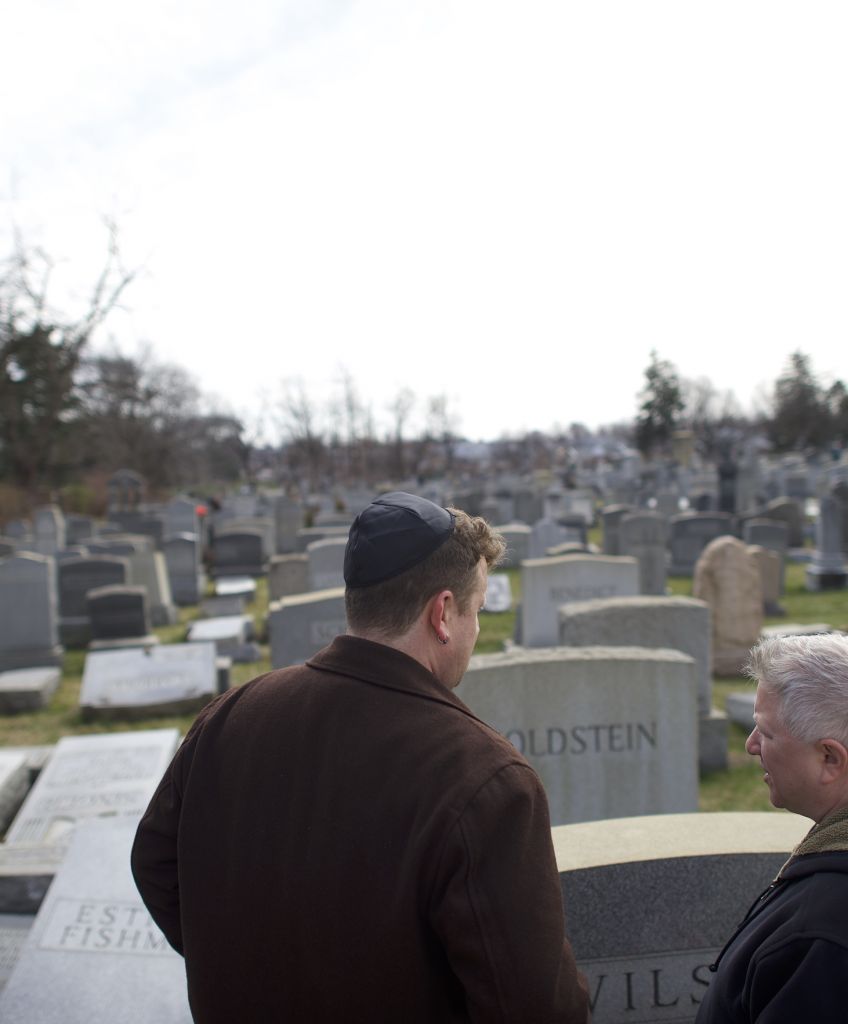 Two men look at Jewish tombstones vandalized at Mount Carmel Cemetery in Philadelphia. (Photo by Mark Makela/Getty Images)