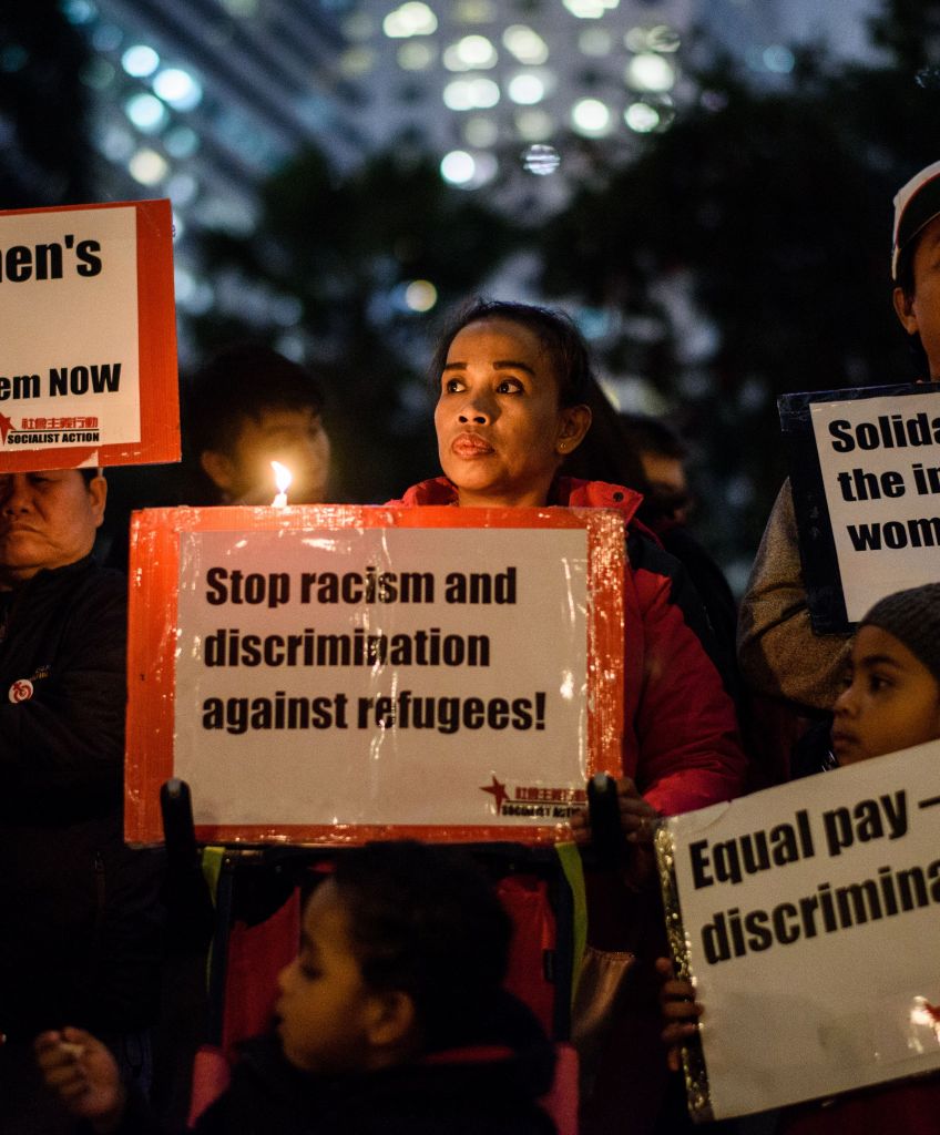Participants hold candles and placards during a vigil to mark International Women's Day in Hong Kong on March 8, 2017. (ANTHONY WALLACE/AFP/Getty Images)
