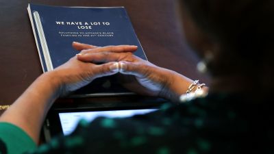 Rep. Brenda Lawrence (D-MI), an executive committee member of the Congressional Black Caucus, has copy of a report titled We Have A Lot To Lose during a meeting with President Trump at the White House on March 22, 2017. (Photo by Chip Somodevilla/Getty Images)