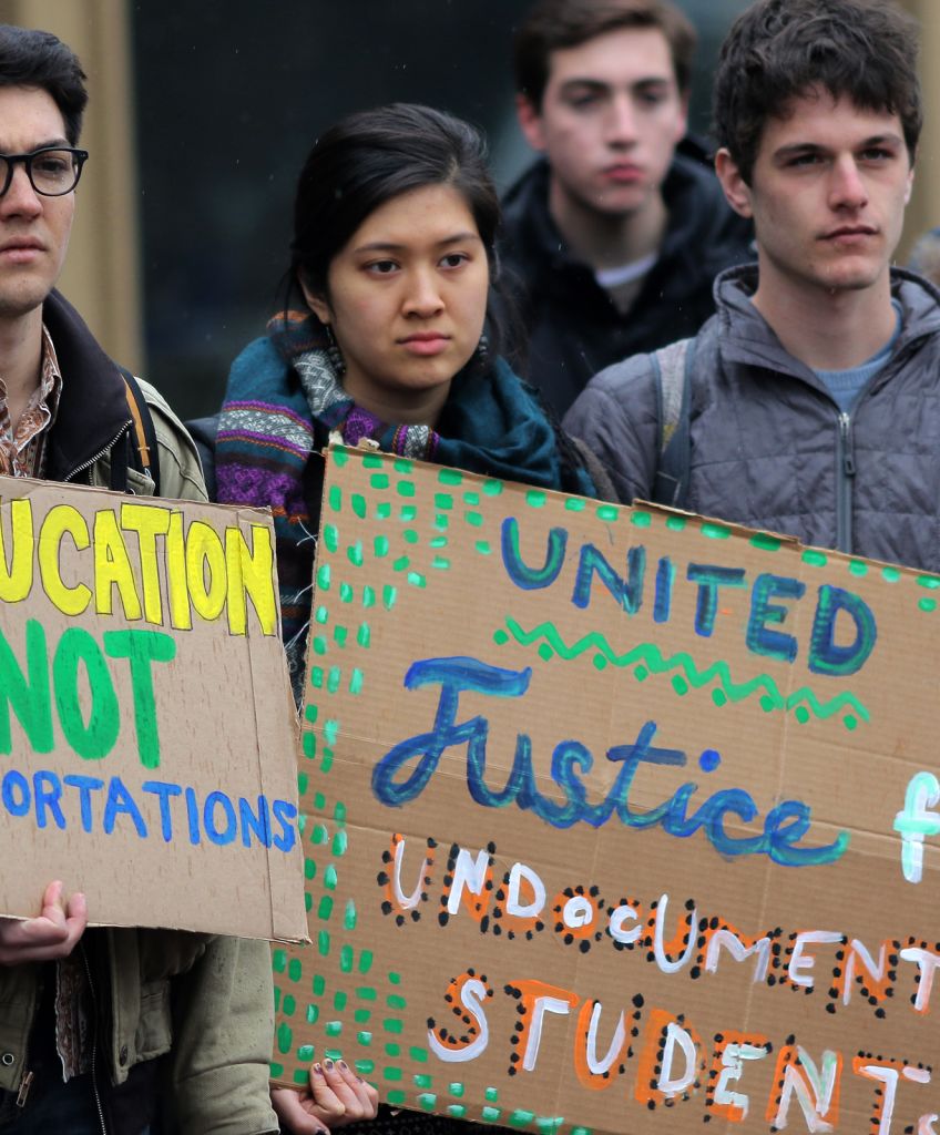 Students participate in a rally at the Tufts University campus on April 7, by the group Tufts United for Immigrant Justice. (Photo by Lane Turner/The Boston Globe via Getty Images)