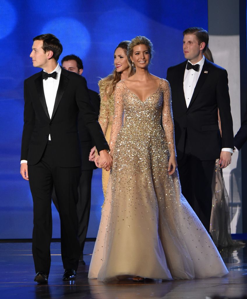Ivanka Trump, her husband Jared Kuschner (L) and brother Eric Trump (R) arrive on stage at the Freedom Inaugural Ball, January 20, 2017, in Washington, DC. / AFP / Robyn Beck (Photo credit should read ROBYN BECK/AFP/Getty Images)
