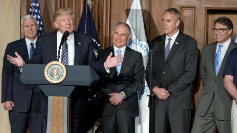 President Donald Trump speaks at EPA headquarters in Washington, DC on March 28, 2017 before signing an energy independence executive order as (from left) Vice President Mike Pence, EPA administrator Scott Pruitt, Secretary of the Interior Ryan Zinke and Secretary of Energy Rick Perry look on. (Photo by Ron Sachs/Pool via Bloomberg)