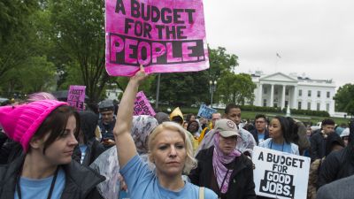 Protestors with People's Action rally against President Donald Trump's budget and agenda at Lafayette Park outside the White House in Washington, DC, April 25, 2017. (Photo by Saul Loeb/AFP/Getty Images)