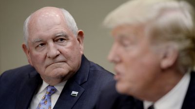 Agriculture Secretary Sonny Perdue listens as President Donald speaks during a roundtable with farmers in the Roosevelt Room of the White House on April 25, 2017. During the meeting Trump signed the Executive Order Promoting Agriculture and Rural Prosperity in America. (Photo by Olivier Douliery-Pool/Getty Images)
