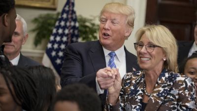 President Donald Trump with Education Secretary Betsy DeVos during an event for School Choice in the Roosevelt Room at the White House on May 3, 2017. (Photo by Aaron P. Bernstein/Bloomberg via Getty Images)